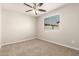 Neutral bedroom with a window offering natural light and a ceiling fan at 5430 W Odeum Ln, Phoenix, AZ 85043