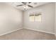 Bedroom featuring a ceiling fan, carpeted floor, and a window for natural light at 5430 W Odeum Ln, Phoenix, AZ 85043