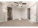 Bright bedroom featuring neutral walls, carpet, and a ceiling fan with lights at 5430 W Odeum Ln, Phoenix, AZ 85043