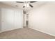 Bedroom featuring built-in closets and a ceiling fan with overhead lighting at 5430 W Odeum Ln, Phoenix, AZ 85043