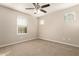 Neutral bedroom with a ceiling fan and a view out the window at 5430 W Odeum Ln, Phoenix, AZ 85043