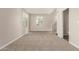 Inviting living room area featuring neutral carpeting and abundant natural light with stairs at 5430 W Odeum Ln, Phoenix, AZ 85043