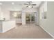 Cozy living room with plush carpeting, ceiling fan, and sliding glass doors for natural light at 5430 W Odeum Ln, Phoenix, AZ 85043