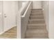 Carpeted staircase leading to the upper level of the home, accented by white trim at 5430 W Odeum Ln, Phoenix, AZ 85043