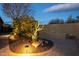 Serene backyard with ambient lighting, drought-tolerant landscaping, and stone accents at 5921 E Ocupado Dr, Cave Creek, AZ 85331