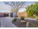 Inviting backyard with lush landscaping, brick pavers, and convenient storage sheds at 5921 E Ocupado Dr, Cave Creek, AZ 85331