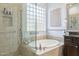 This bathroom features a glass shower and a soaking tub with a glass block window for natural light at 5921 E Ocupado Dr, Cave Creek, AZ 85331