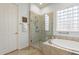 Luxurious bathroom featuring a glass-enclosed shower, a soaking tub, and a stylish tile surround at 5921 E Ocupado Dr, Cave Creek, AZ 85331