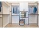 A walk-in closet with custom shelving and cabinetry featuring a vanity and stool at 5921 E Ocupado Dr, Cave Creek, AZ 85331