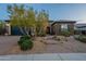 Charming home with a well-maintained yard and inviting stone pathway at 5921 E Ocupado Dr, Cave Creek, AZ 85331