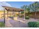 Backyard gazebo featuring a fire pit, patio furniture, brick floor, and privacy landscaping at 5921 E Ocupado Dr, Cave Creek, AZ 85331