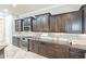 Modern kitchen featuring granite countertops, dark wood cabinets, and stainless steel appliances at 5921 E Ocupado Dr, Cave Creek, AZ 85331