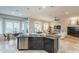 Open concept kitchen featuring a large granite island that overlooks the adjacent living room at 5921 E Ocupado Dr, Cave Creek, AZ 85331