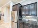 Stylish kitchen with stainless steel refrigerator and dark cabinets at 5921 E Ocupado Dr, Cave Creek, AZ 85331