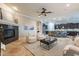 Open concept living area featuring tile floors, a fireplace, and adjacent kitchen at 5921 E Ocupado Dr, Cave Creek, AZ 85331