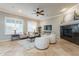 Bright living room with a fireplace, large windows, and neutral-toned decor at 5921 E Ocupado Dr, Cave Creek, AZ 85331