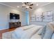 Serene main bedroom showcasing hardwood floors, modern decor, and a large television for relaxing evenings at 5921 E Ocupado Dr, Cave Creek, AZ 85331