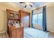 A home office featuring custom wood cabinetry, a desk, and a window with blue curtains at 5921 E Ocupado Dr, Cave Creek, AZ 85331