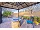 Cozy outdoor seating area with a stone fire pit and ample space for entertaining at 5921 E Ocupado Dr, Cave Creek, AZ 85331