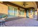 Covered patio featuring a ceiling fan, tan brick floor, water feature, and views of the backyard at 5921 E Ocupado Dr, Cave Creek, AZ 85331