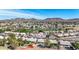 Expansive aerial view of a desert community featuring well-maintained homes and lush landscaping near a beautiful golf course at 6401 W Irma Ln, Glendale, AZ 85308