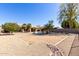 Spacious backyard featuring desert landscaping and a sparkling pool with a covered patio at 6401 W Irma Ln, Glendale, AZ 85308