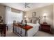 Inviting bedroom with ceiling fan and natural light, showcasing a comfortable and relaxing space at 6401 W Irma Ln, Glendale, AZ 85308