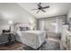 Serene bedroom with decorative ceiling fan, accent lighting, neutral colored walls, and patterned area rug at 6401 W Irma Ln, Glendale, AZ 85308