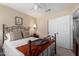 Well-lit bedroom with ceiling fan and closet, offering a cozy and functional living space at 6401 W Irma Ln, Glendale, AZ 85308