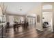 Bright dining area featuring wood floors and view to the living spaces and pool at 6401 W Irma Ln, Glendale, AZ 85308