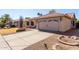 Charming single-story home featuring a two-car garage, neutral stucco exterior, and desert landscaping at 6401 W Irma Ln, Glendale, AZ 85308