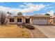 Charming single-story home with a well-manicured lawn and two car garage at 6401 W Irma Ln, Glendale, AZ 85308