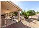 Relaxing covered patio area with tile flooring, rocking chairs and views of the fenced pool at 6401 W Irma Ln, Glendale, AZ 85308