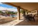 Expansive covered patio area with outdoor seating, perfect for entertaining by the beautiful pool at 6401 W Irma Ln, Glendale, AZ 85308