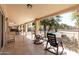 Relaxing covered patio area with tile flooring, rocking chairs and views of the fenced pool at 6401 W Irma Ln, Glendale, AZ 85308