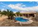 Gorgeous backyard pool with rock waterfall feature and ample space for outdoor enjoyment at 6401 W Irma Ln, Glendale, AZ 85308