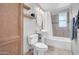 A classic bathroom featuring a pedestal sink, neutral tile and a bathtub with shower at 6524 N 13Th St, Phoenix, AZ 85014