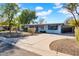 A single story home with a large drive way and desert landscaping at 6524 N 13Th St, Phoenix, AZ 85014