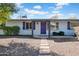 Charming home with purple door and shutters and low maintenance desert landscaping at 6524 N 13Th St, Phoenix, AZ 85014