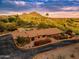 Panoramic aerial shot of an estate showcasing a red tile roof, manicured landscaping, and picturesque mountain views at 6845 N Hillside Dr, Paradise Valley, AZ 85253