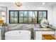 Bright bathroom features a modern tub, double sink, and an expansive window showcasing desert landscaping at 6845 N Hillside Dr, Paradise Valley, AZ 85253