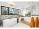 Bright bathroom features a modern tub, double sink, and an expansive window showcasing desert landscaping at 6845 N Hillside Dr, Paradise Valley, AZ 85253