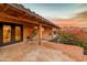 Inviting covered front porch featuring flagstone flooring, brick accents, and lush landscaping with mountain views at 6845 N Hillside Dr, Paradise Valley, AZ 85253