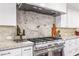 Chef's kitchen with stainless steel oven and range hood with tile backsplash at 6845 N Hillside Dr, Paradise Valley, AZ 85253