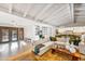 Open-concept living area with exposed beam ceiling, hardwood floors, and seamless flow to other spaces at 6845 N Hillside Dr, Paradise Valley, AZ 85253