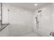 Modern walk-in shower with white marble tile and dual shower heads at 6845 N Hillside Dr, Paradise Valley, AZ 85253