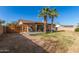 This backyard with a covered patio offers a mix of grassy and dirt areas at 699 W Shannon St, Chandler, AZ 85225