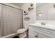 Clean bathroom with modern vanity, framed mirror, and patterned shower curtain at 699 W Shannon St, Chandler, AZ 85225