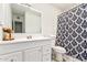 This bathroom offers a vanity with drawers and a black and white patterned shower curtain at 699 W Shannon St, Chandler, AZ 85225