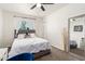 Comfortable bedroom with a plush bed, natural light, and a full length mirror at 699 W Shannon St, Chandler, AZ 85225